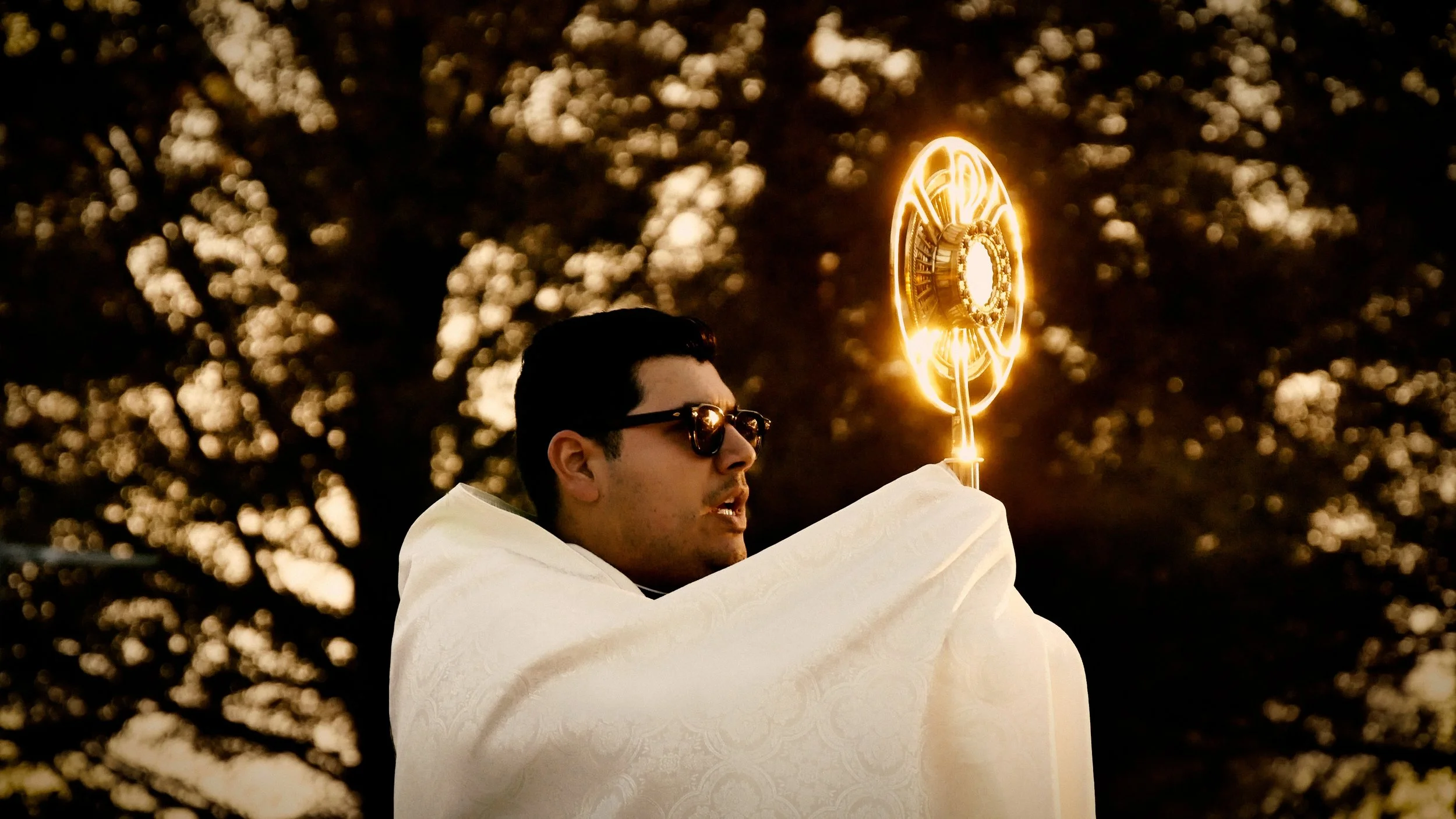 Fr. Max with glowing monstrance.jpg