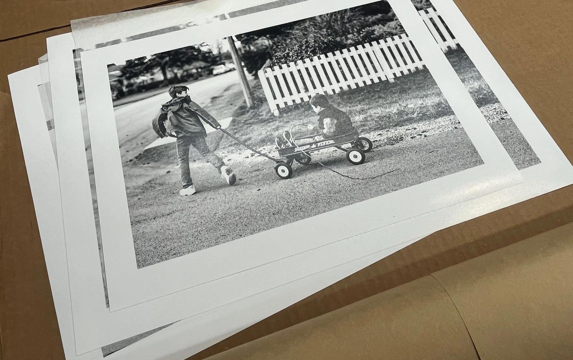 Stack of fine art photographic prints by Andrew Legere, showcasing premium archival print quality for Legere Fine Art Services.