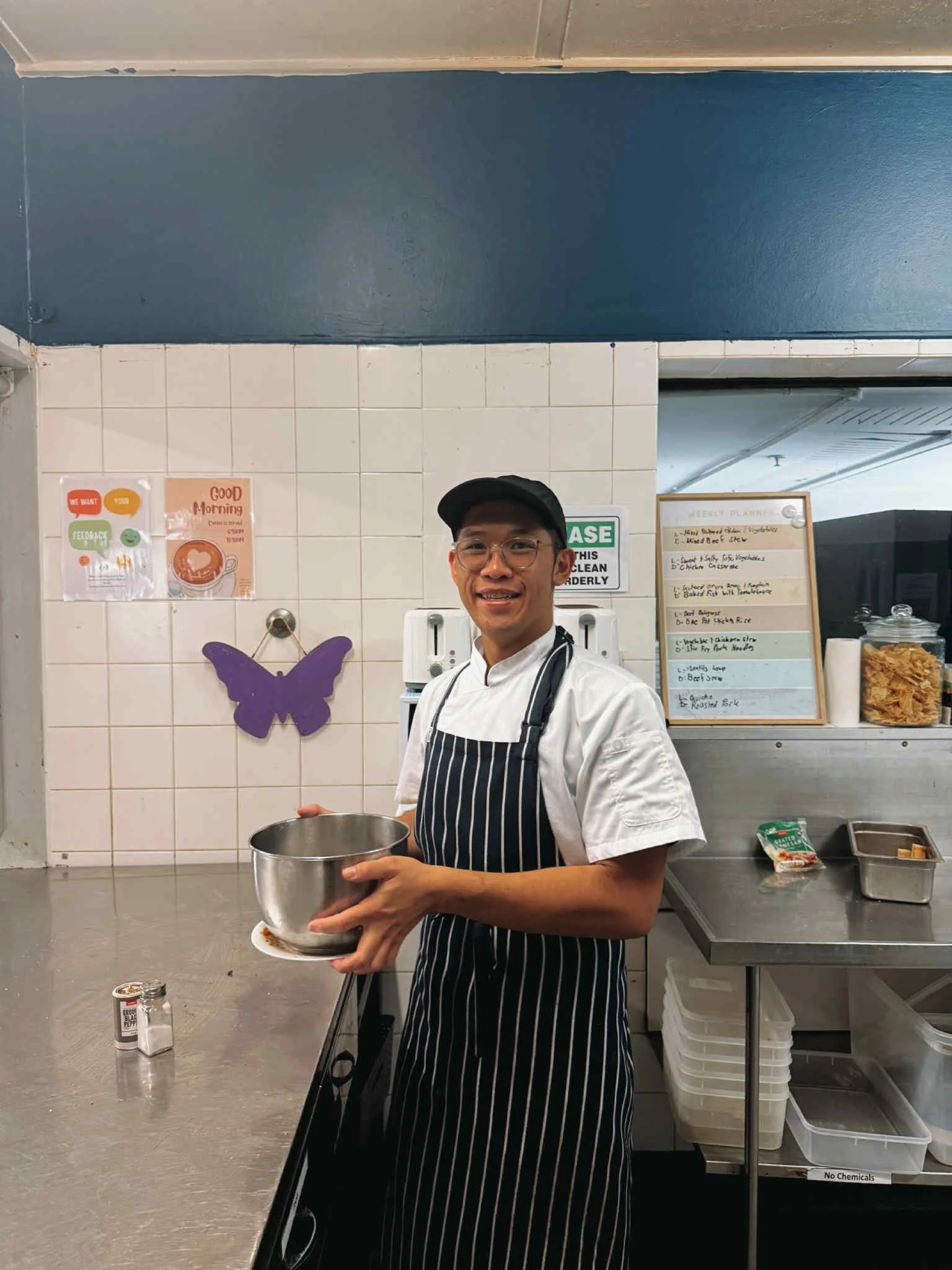 NDIS participant developing work skills in a commercial kitchen as part of supported employment and independence-building programs.