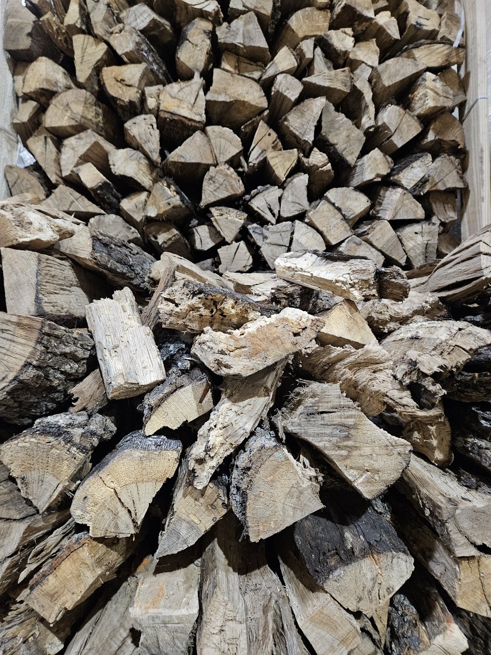 Stacked firewood logs arranged in a pile.