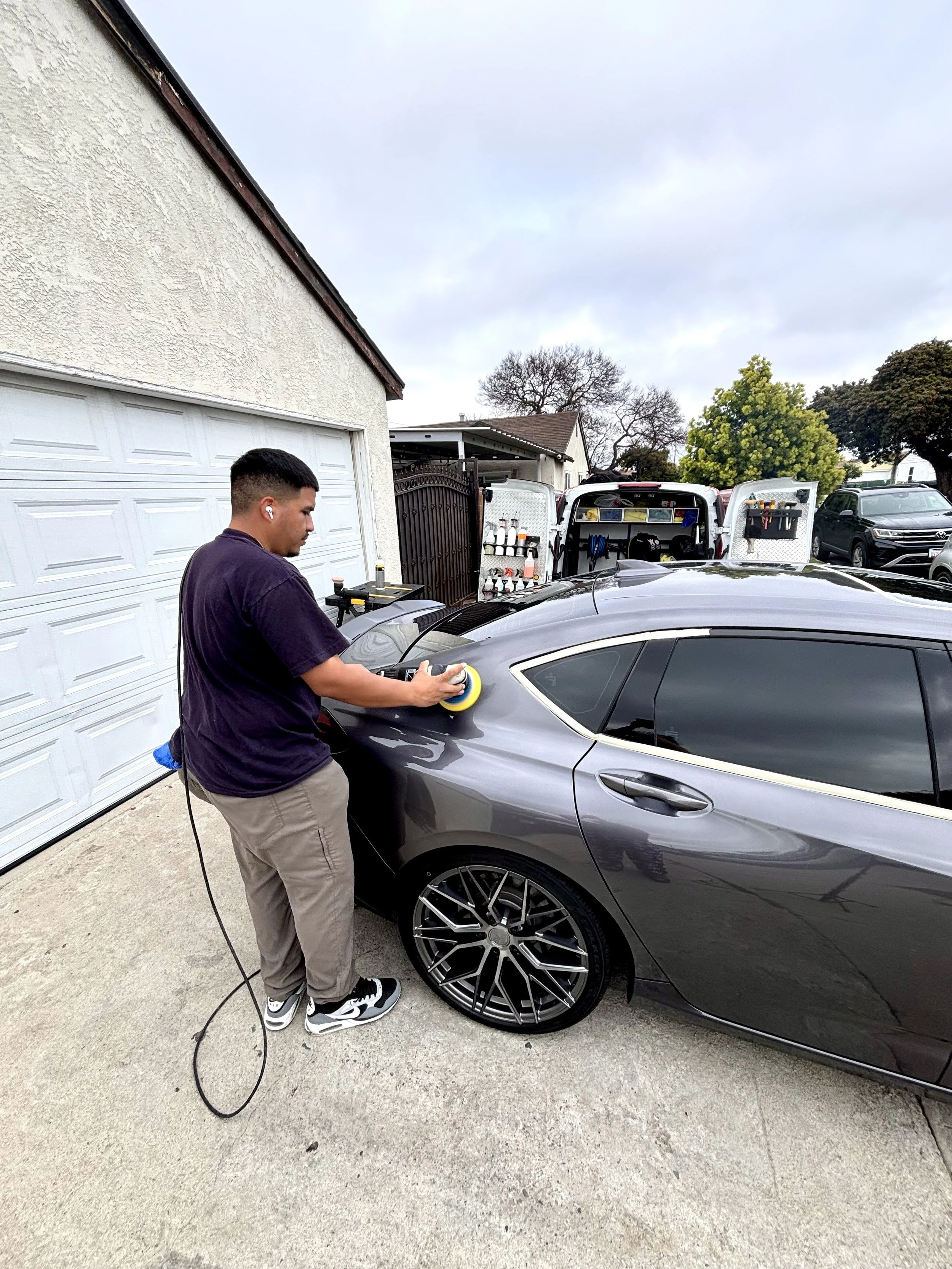 Mobile detailer polishing a car in Lakewood.