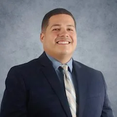 Ramon Casanova smiling with short dark brown hair