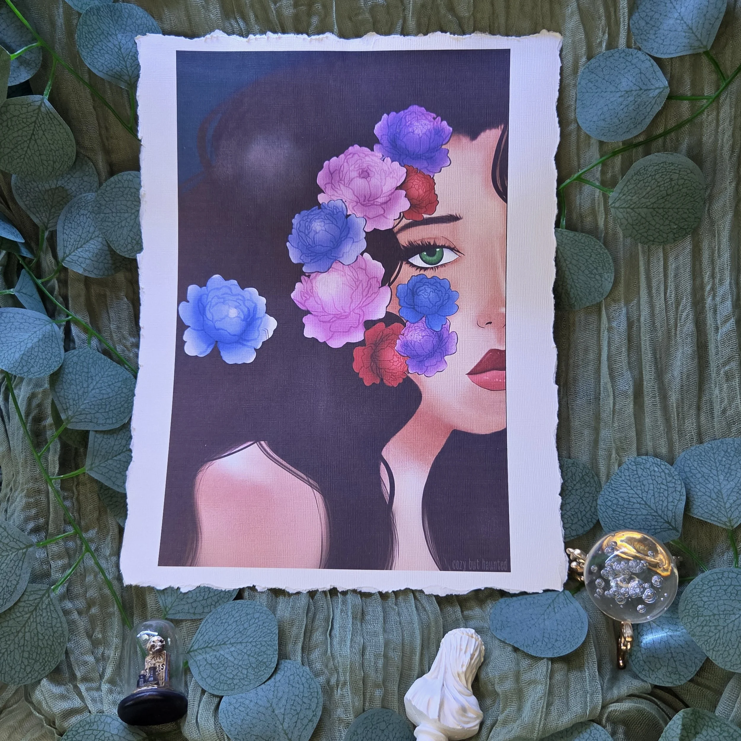 Drawing of a woman’s face partially covered by pink and purple flowers against a dark background on linen textured card stock with deckled edging.