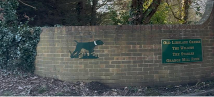a photo of the entrance way to woof wash and trim, signalled by a big green dog
