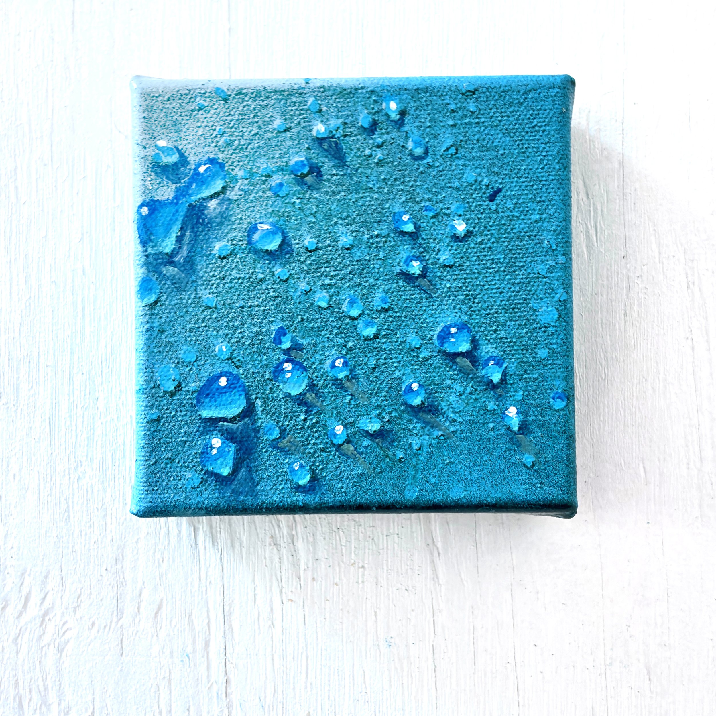 Painting of drops of water on a blue background