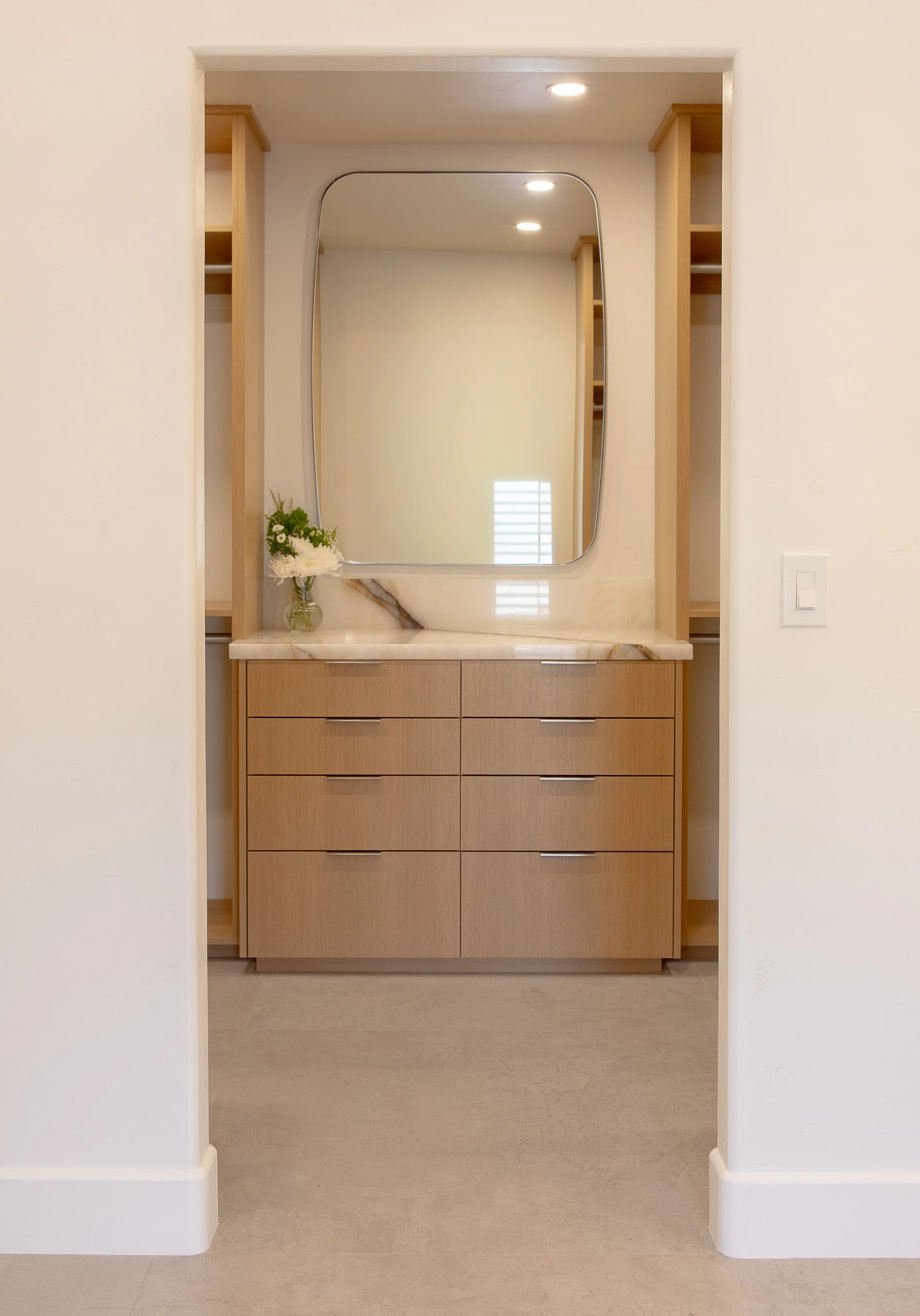 white oak dresser quartzite countertop rounded rectangular brushed nickel mirror custom built in closet