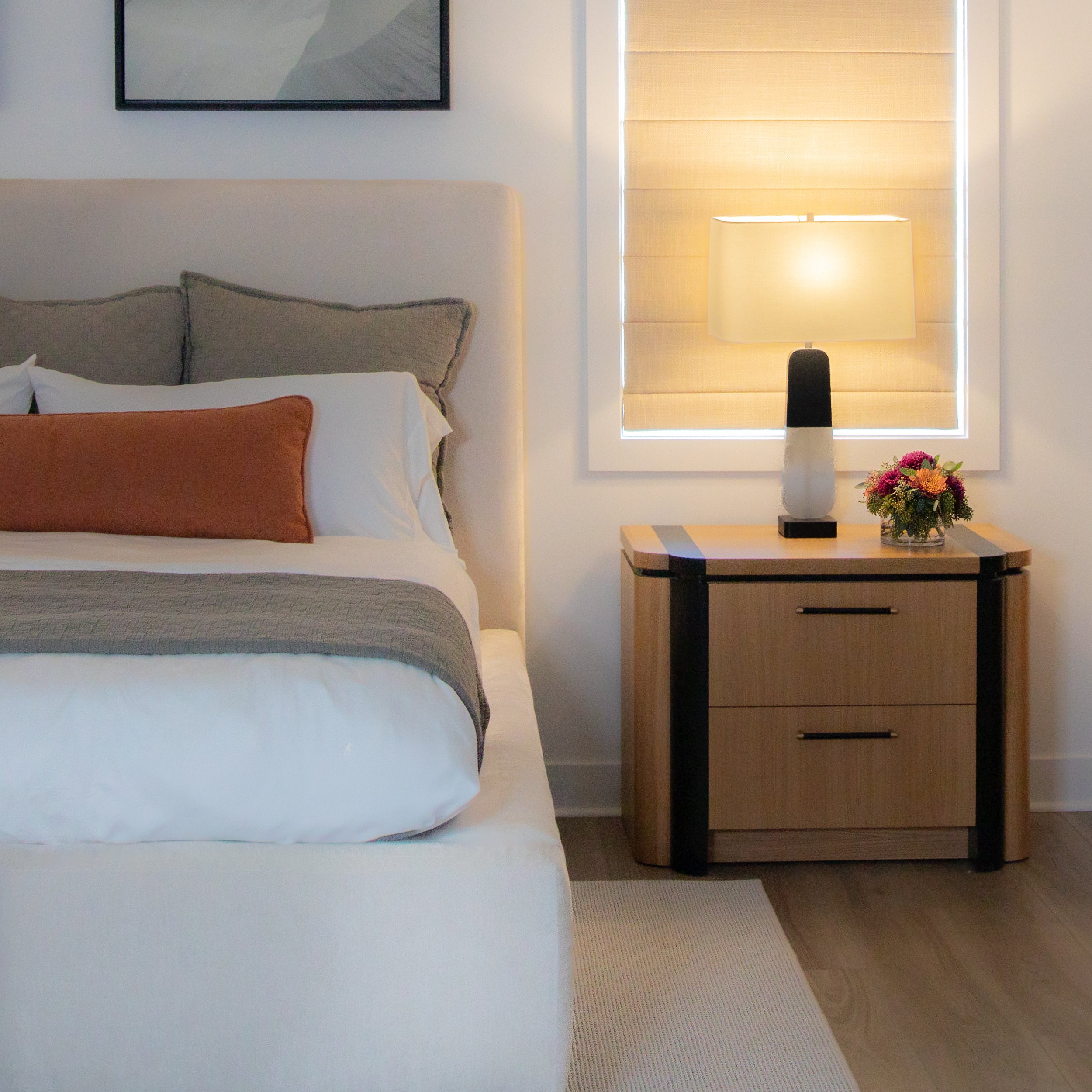 close up white oak curved nightstand black stain detail alabaster lamp velvet upholstered custom bed 