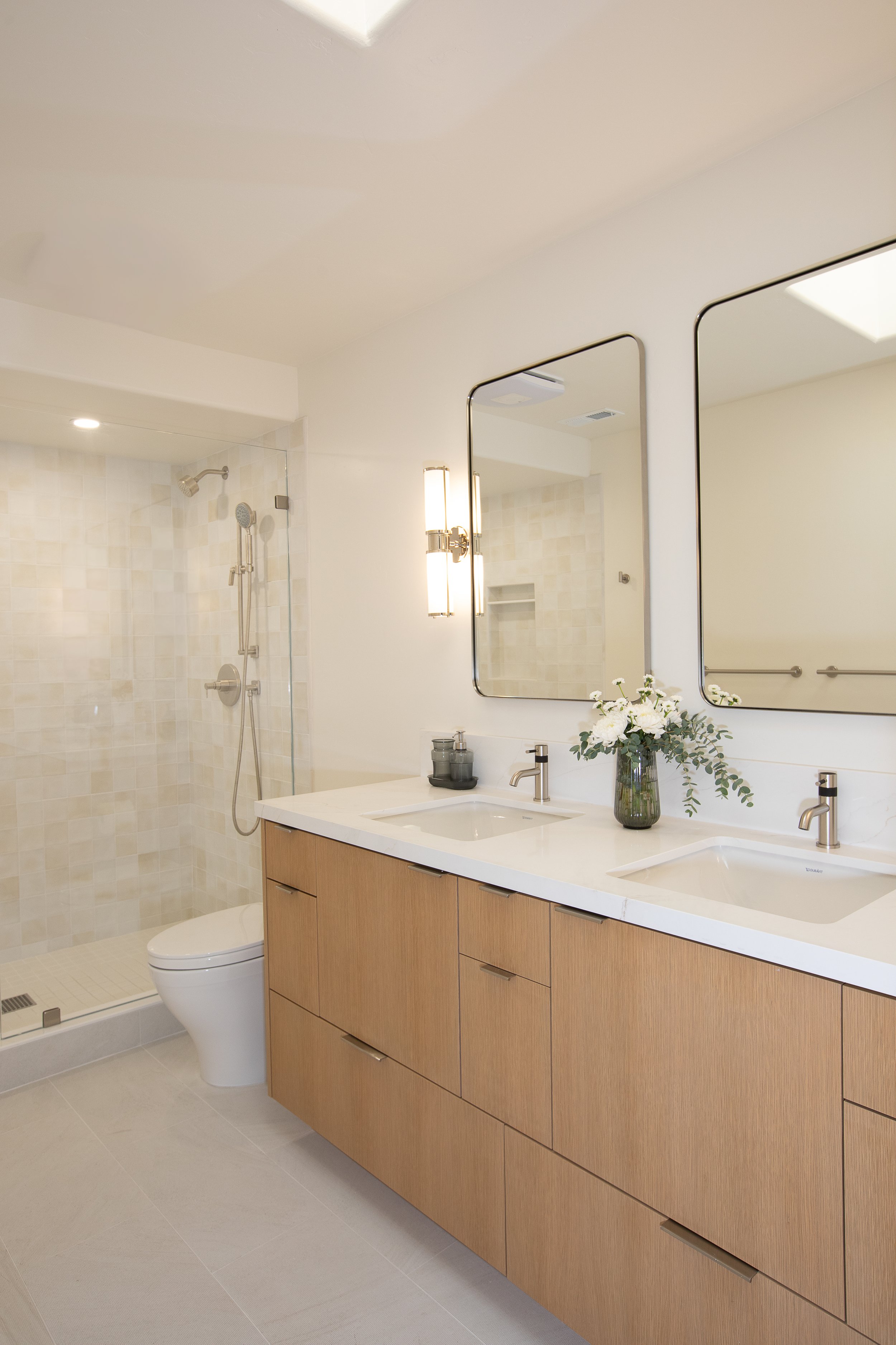 modern minimalist bathroom double vanity rift cut white oak vanity glass sconces square textured shower tile 