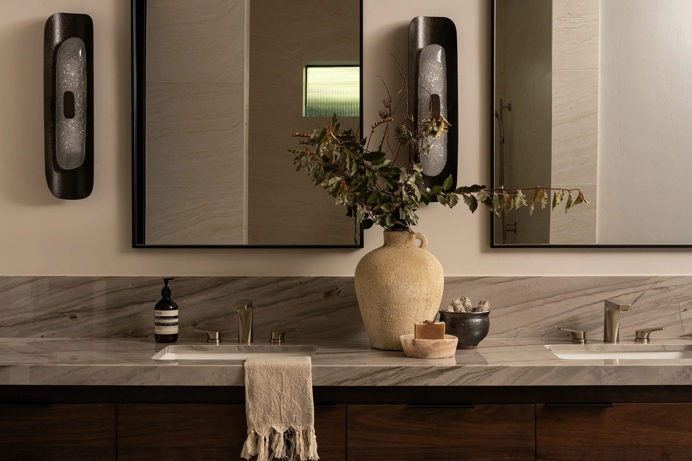 Walnut double vanity with Silver Moon quartzite counter in a La Jolla primary bath