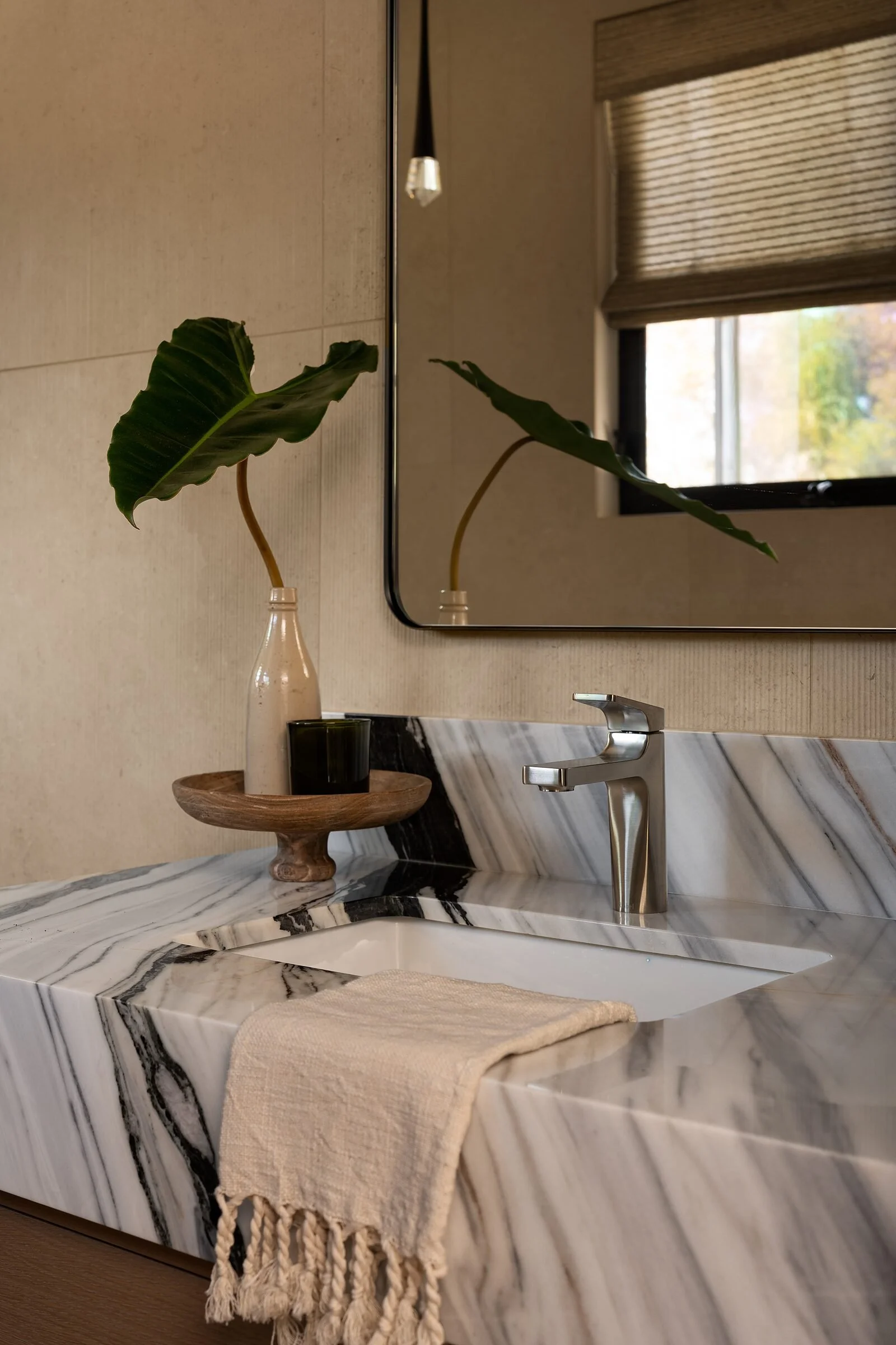 Bianco Lasa marble vanity and tub deck detail in a spa bath