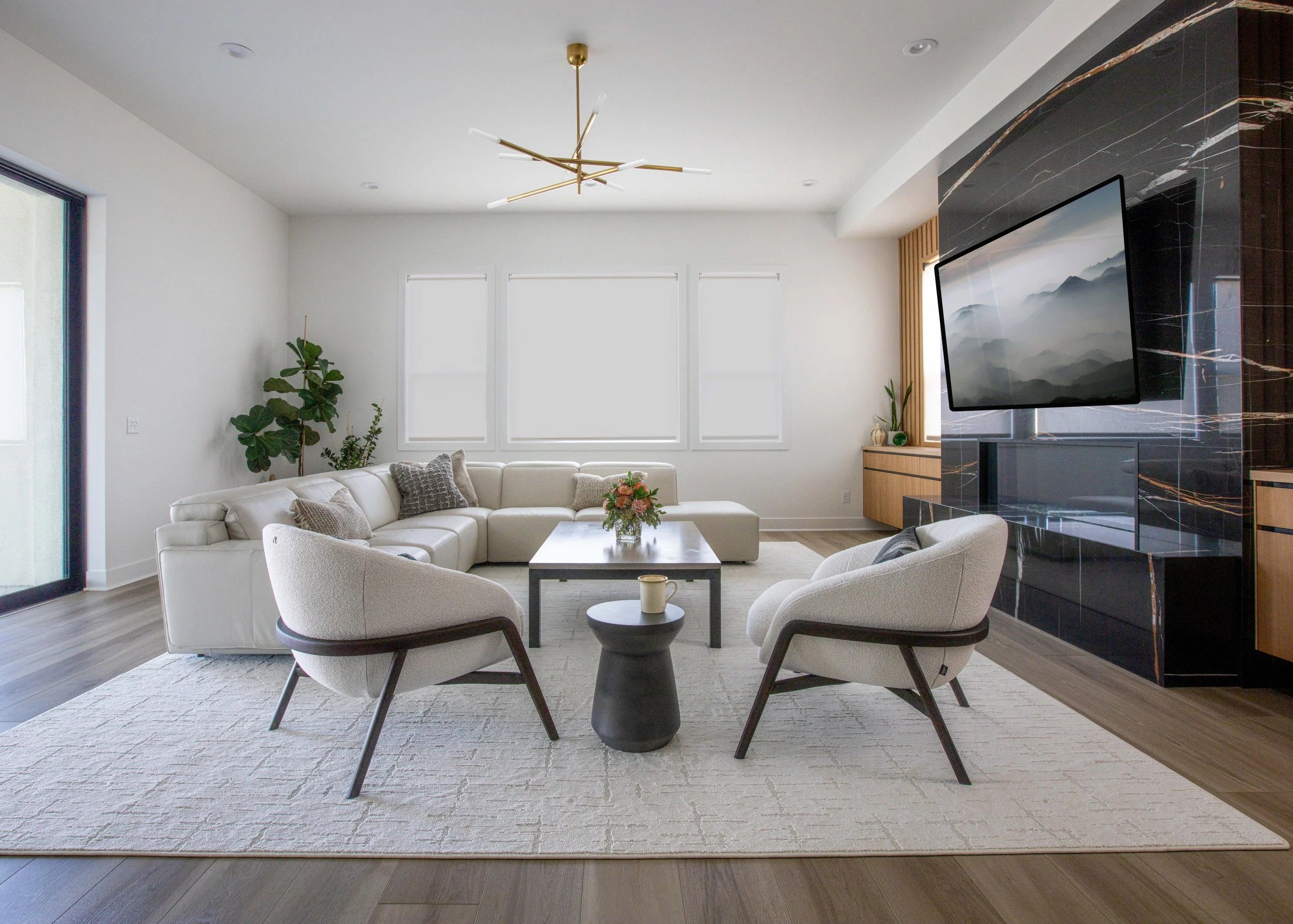 white upholstered curved chairs black wood frame black marble fireplace 