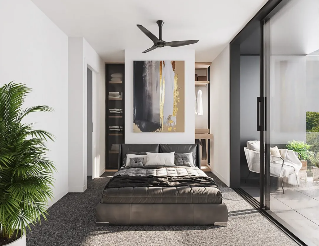 Modern bedroom with a gray bed, abstract wall art, black shelving, a ceiling fan, and sliding glass doors leading to an outdoor seating area