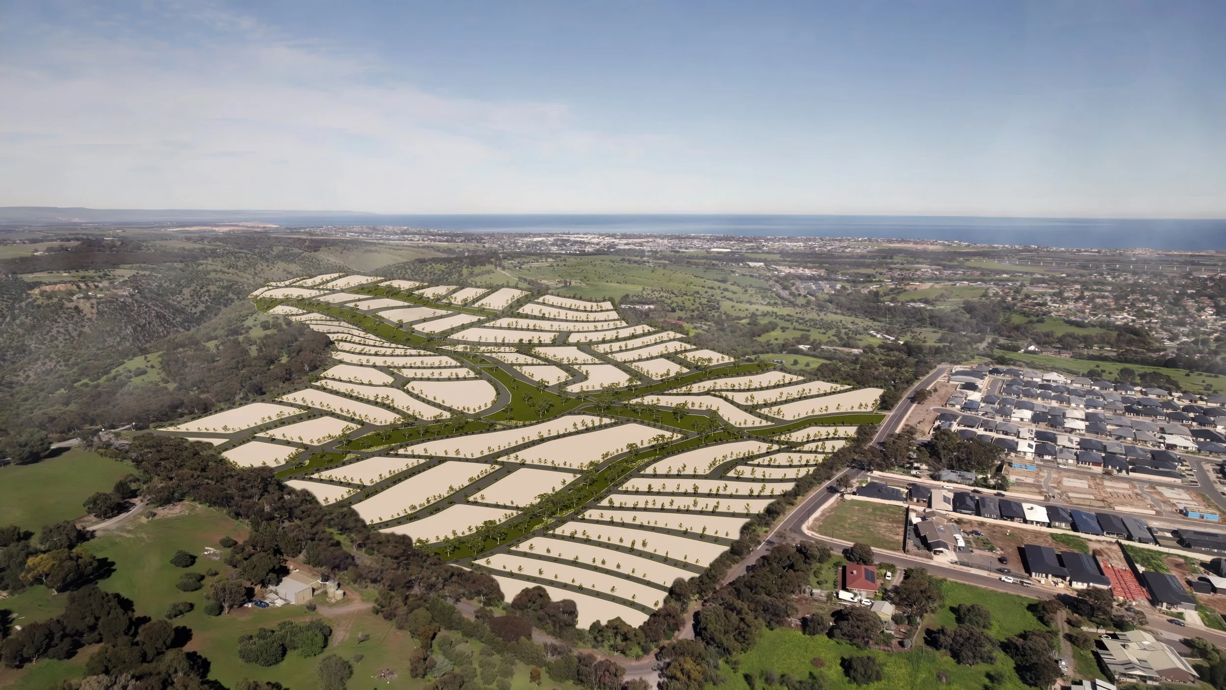 Aerial view of a large urban development site with farmland, trees, and residential neighborhoods, overlooking a coastal city and ocean in the background. Onkaparinga Heights, YAS Property and Development. Land coming soon. Masterplanned development.