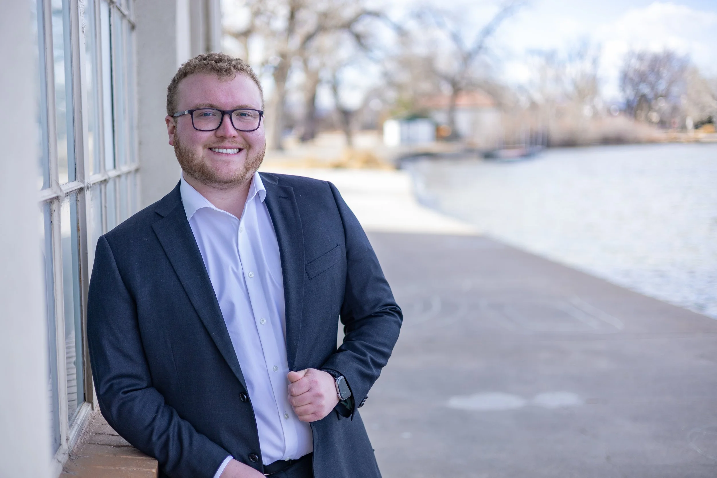 Matt Walter leaning casually against Washington Park boat house.