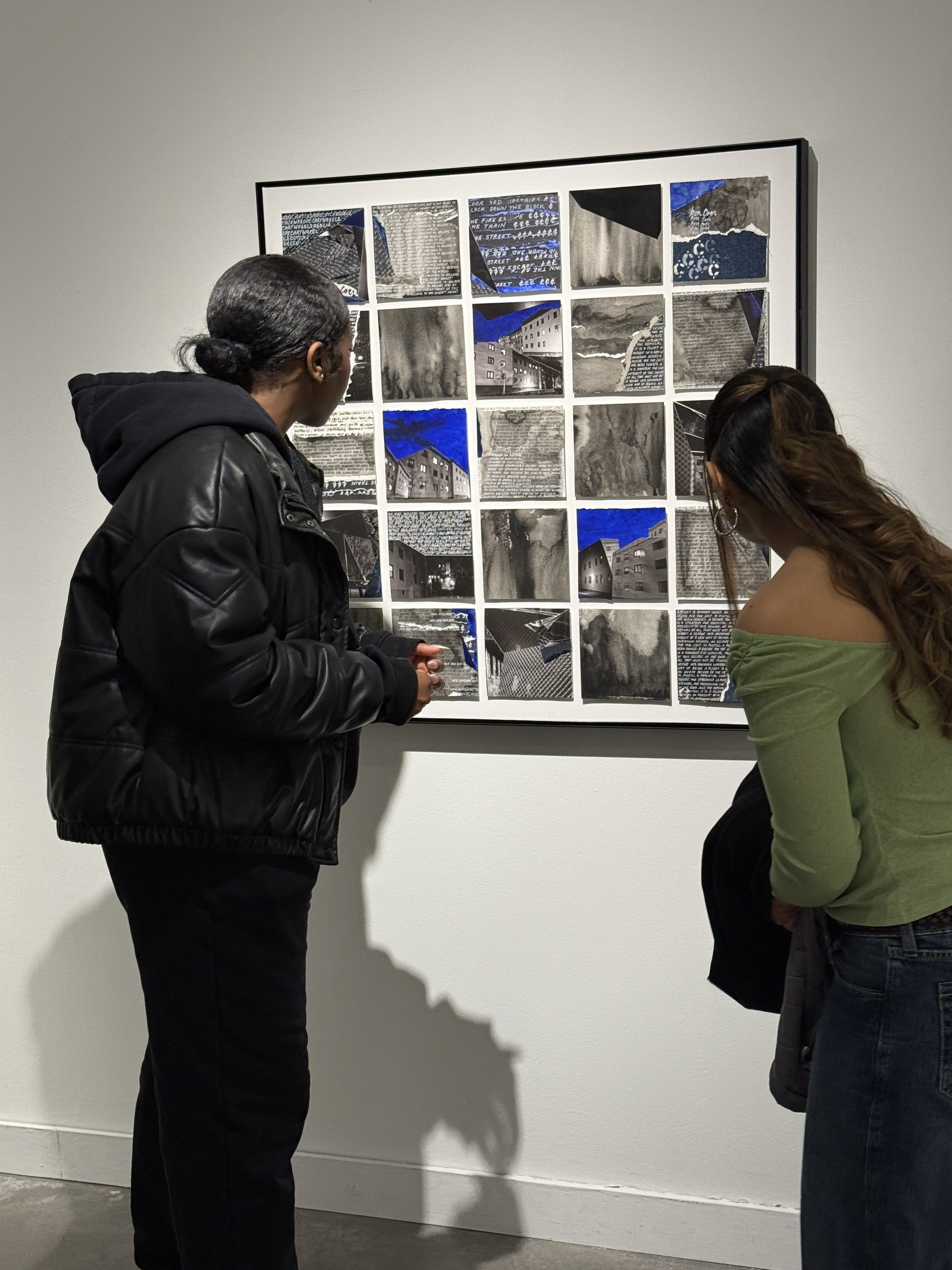 Magda Parasidis at Urban Arts Space Columbus OH OSU Ohio State Artist Commune Kite exhibition observing a framed collage of black and white photographs and some with blue accents, displayed on a gallery wall.