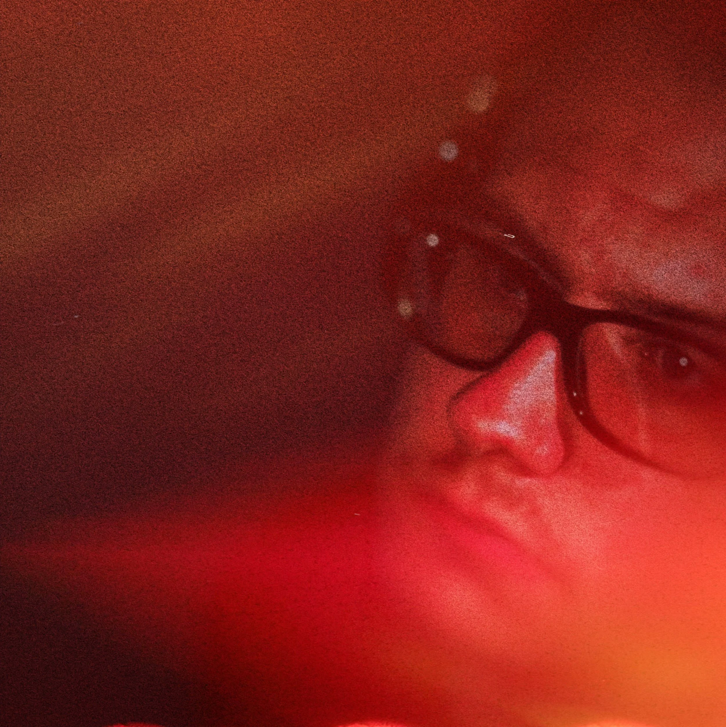Close-up portrait of Camden Tenney Hicks with red and deep amber photo tarnishes