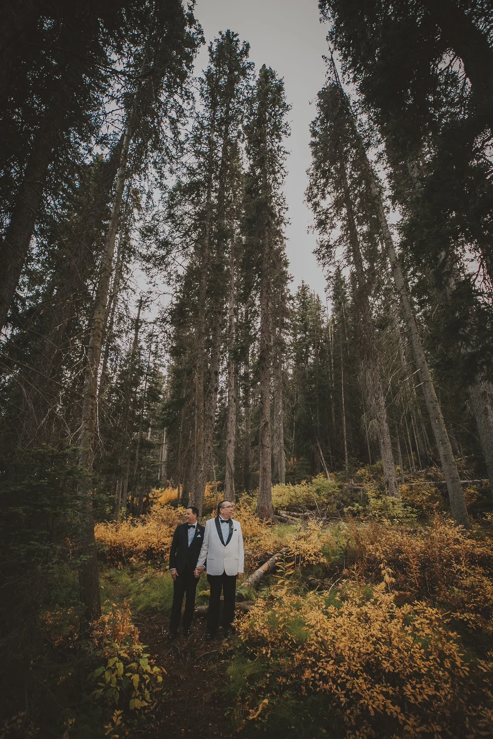 bride-embracing-woman-lake-banff-canadian-rockies.webp