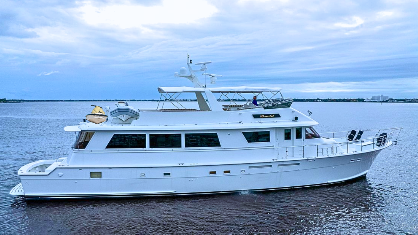 A large white yacht on the water with a guy sitting on the upper deck, fishing, and a small boat on the roof.