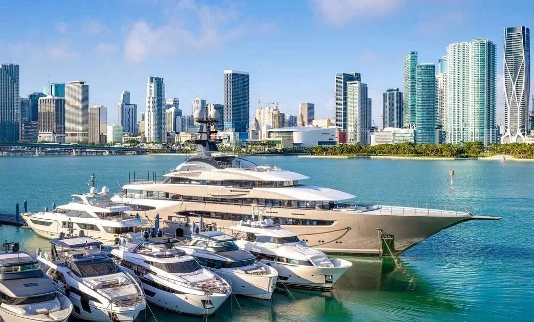 Colorful foam buoys hanging on strings at a market stall, with many different colors and sizes.