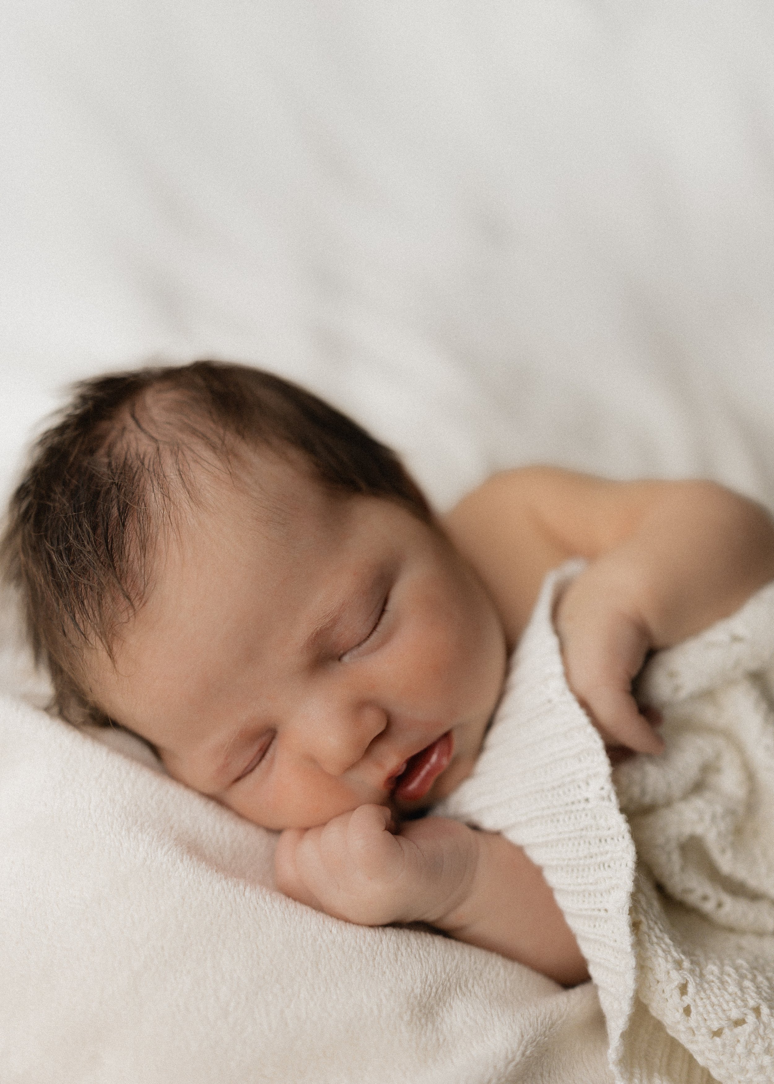 baby sleeping peacefully at home during photoshoot