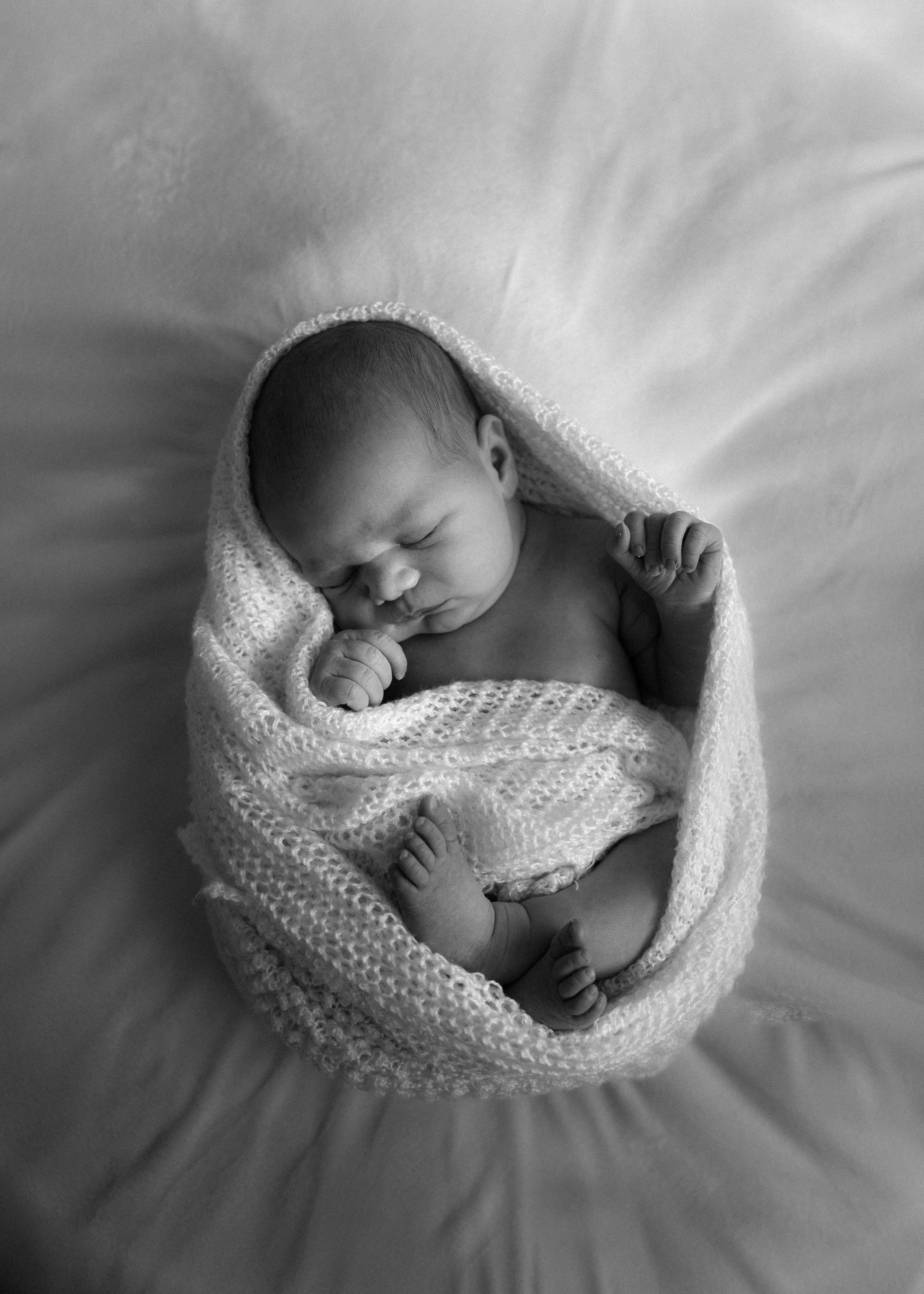black and white photo sleeping newborn in home session