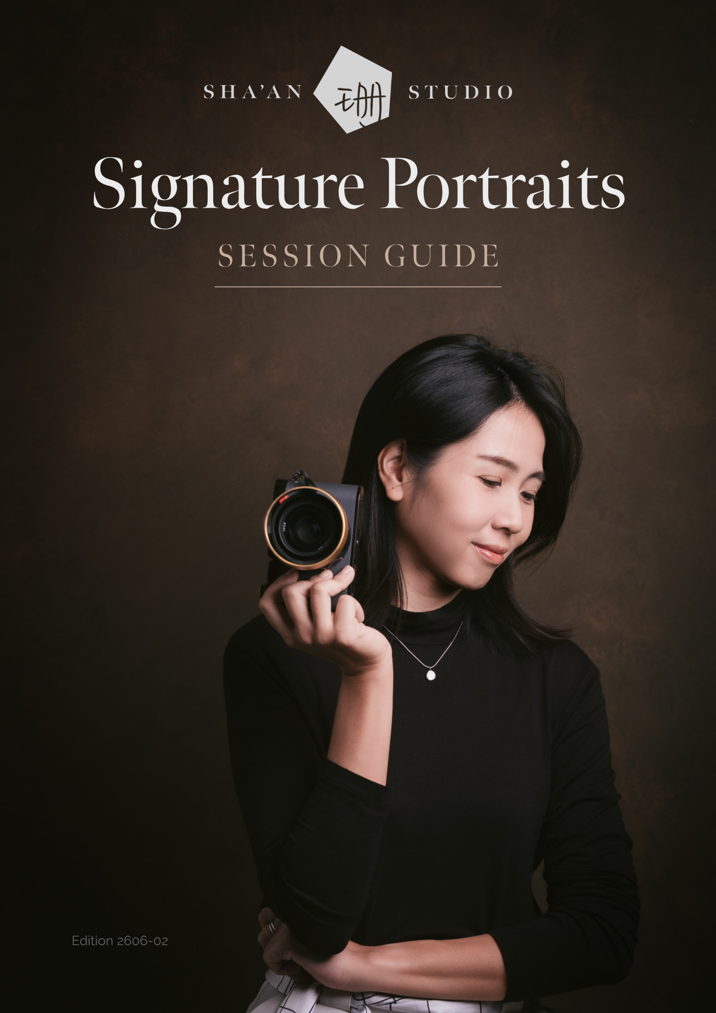 Cover page of Signature Portraits session guide for Singapore portrait photographer Sha’an Ng holding her camera in the studio.