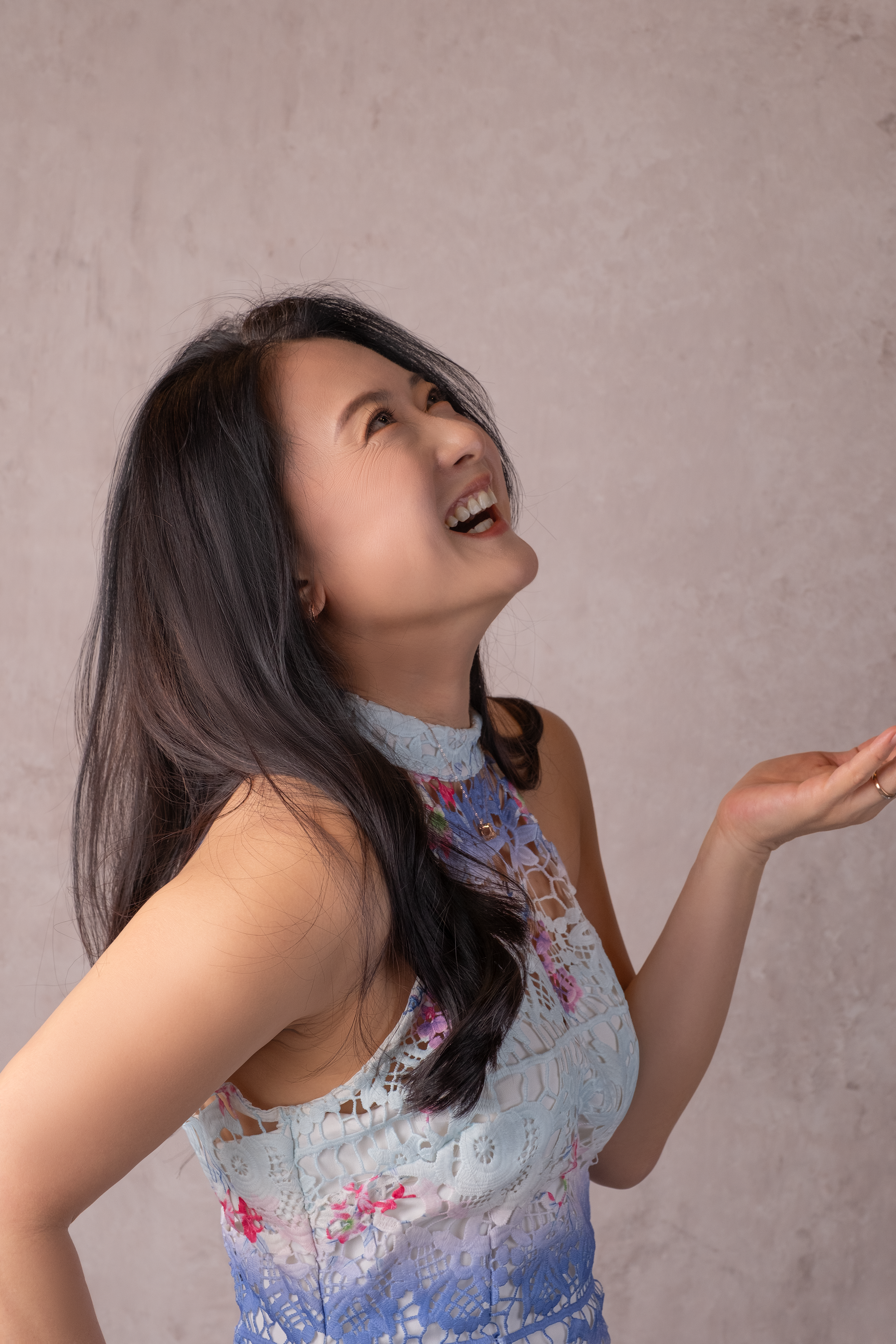 Woman laughing during a candid portrait session in a photography studio