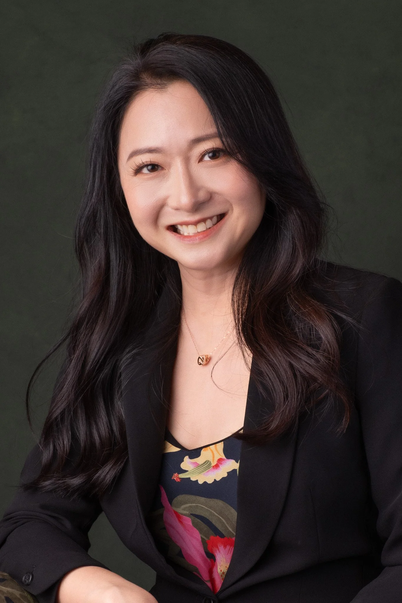 Corporate headshot for HL Bank (Singapore) manager, Melissa Goh. She is smiling at the camera with her head slightly tilted to the side. 
