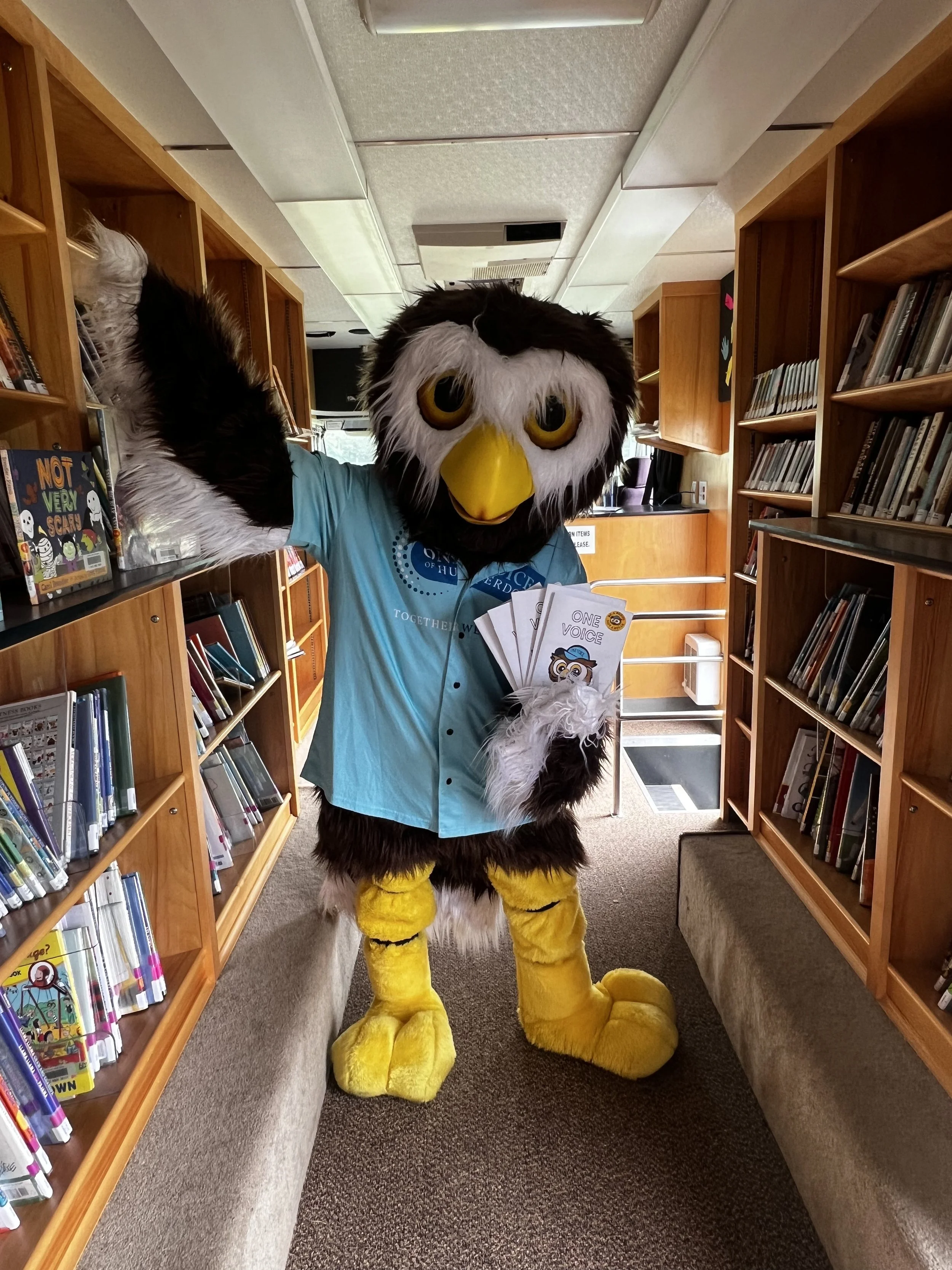 Owlbert holding coloring books in Mobil library.jpeg