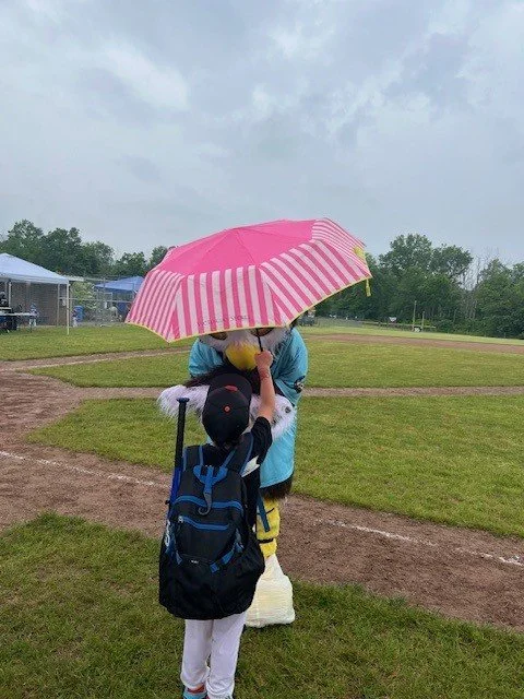 Child holding umbrella over Owlbert.jpg