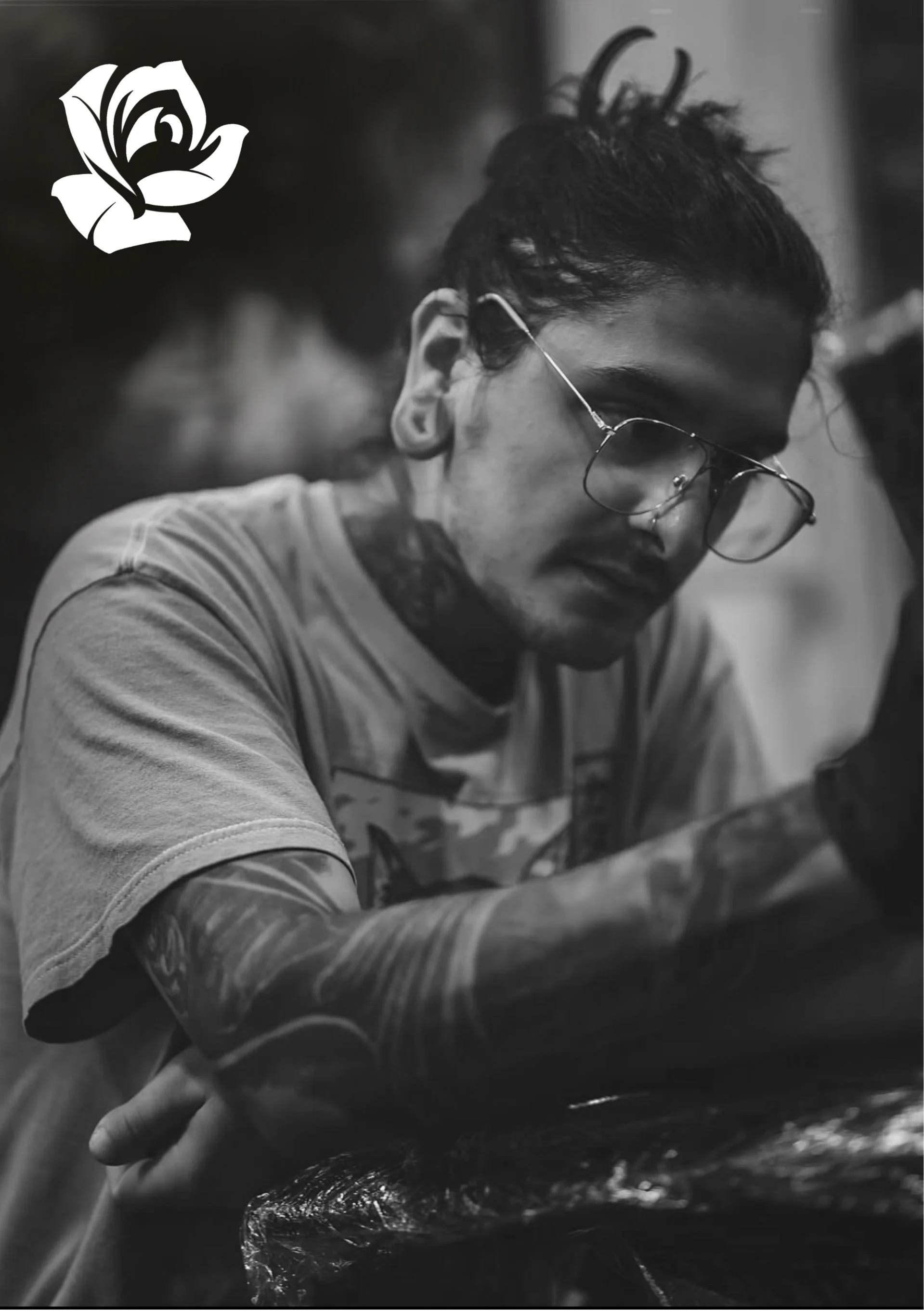 A black and white head shot of artist Nic Dimas