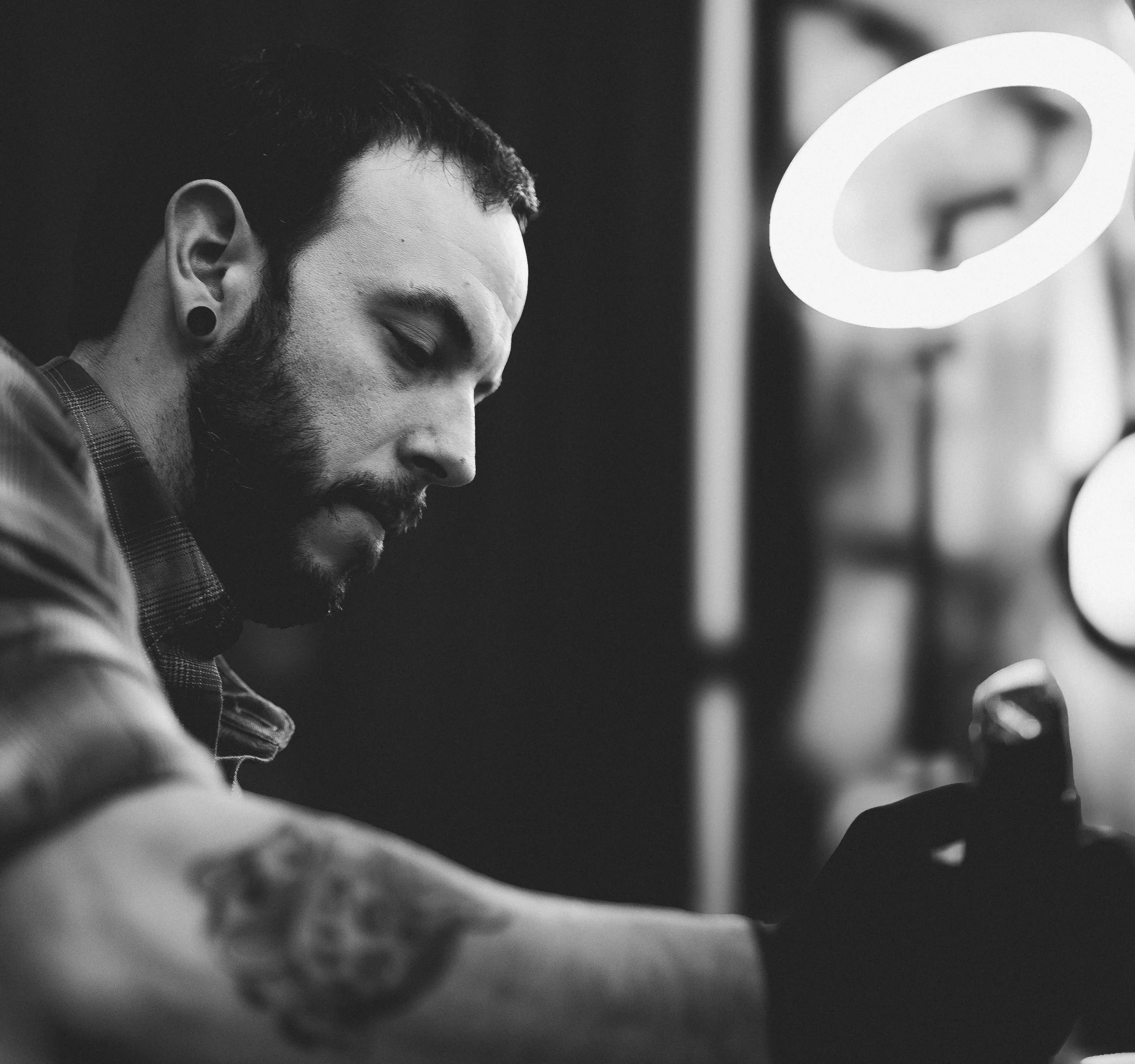 A black and white head shot of aritst Jon Bon.