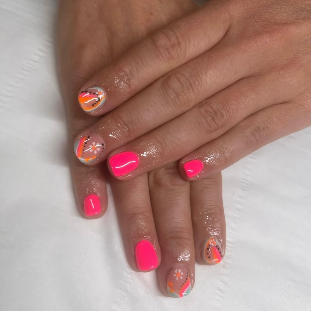 Close-up of hands receiving a manicure with nail polish applied