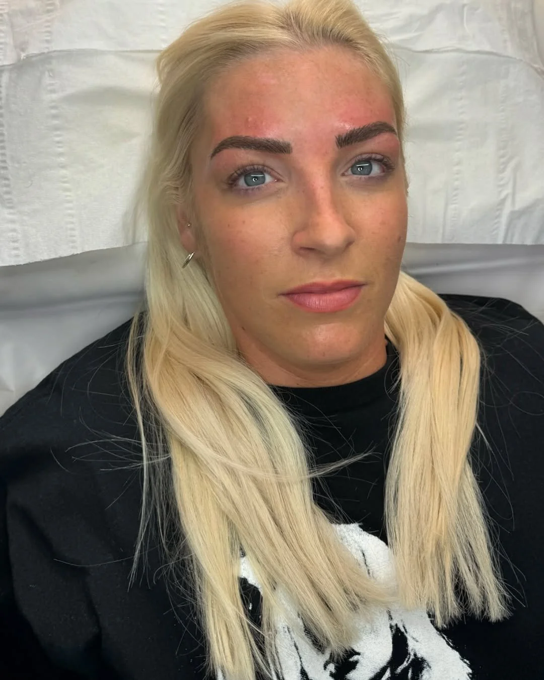 Client receiving a facial treatment with cleansing mask applied