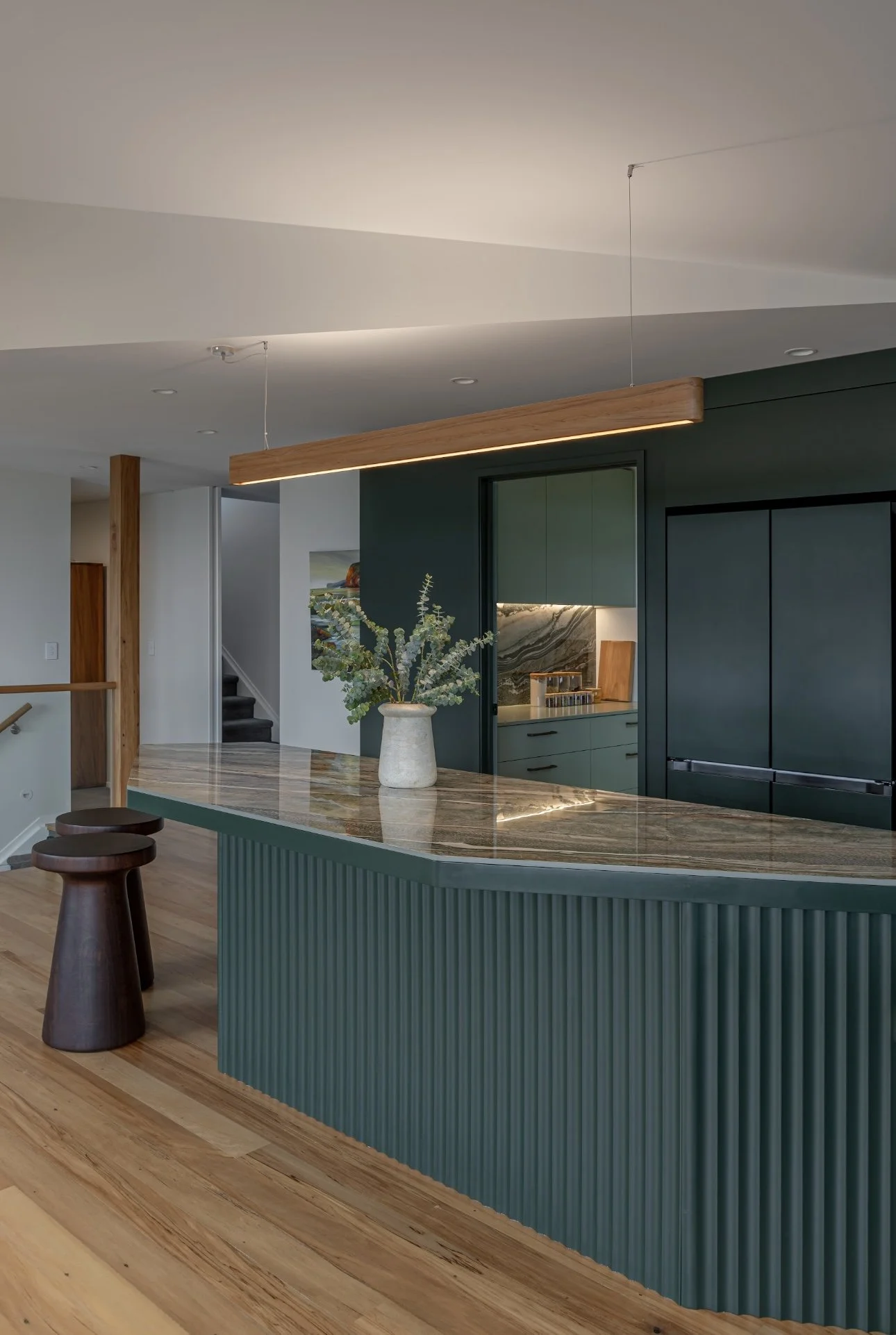 Kitchen island benchtop in Royal Peacock porcelain, polished marble-look surface