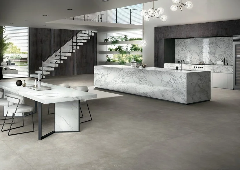 Contemporary open-plan interior with Extra Statuario porcelain island and benchtops, white marble-look surface with seamless continuity