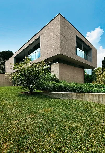 Exterior facade clad in Milan Stone porcelain, matte grey stone-look surface