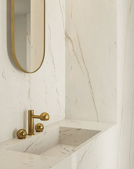 Bathroom wall detail in Calacatta Brasile porcelain, satin marble-look surface with golden veining