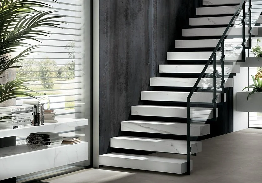 Extra Statuario porcelain staircase and wall cladding, white marble-look surface with subtle veining in a modern interior