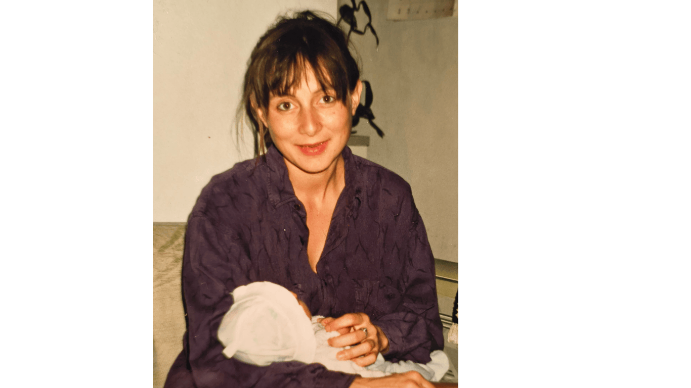 Mother, smiling with her newborn baby in her arms, Colette Ozanne, massage therapist, closing the bones South London and Lambeth