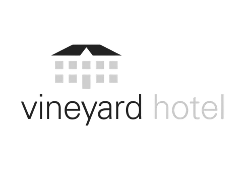 Vineyard Hotel logo with a graphic of a house above the text.