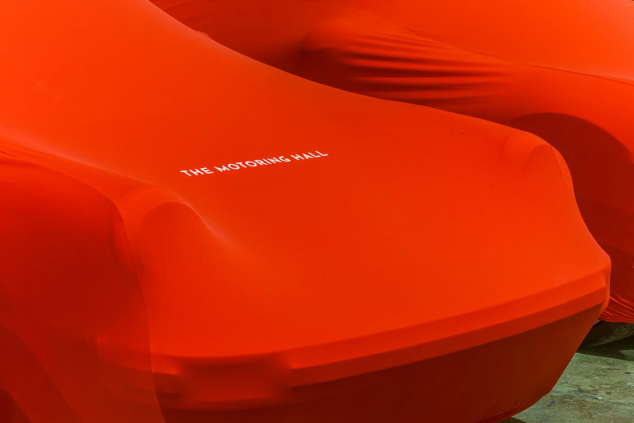 Orange cover with the text 'The Motoring Hall' printed on it.