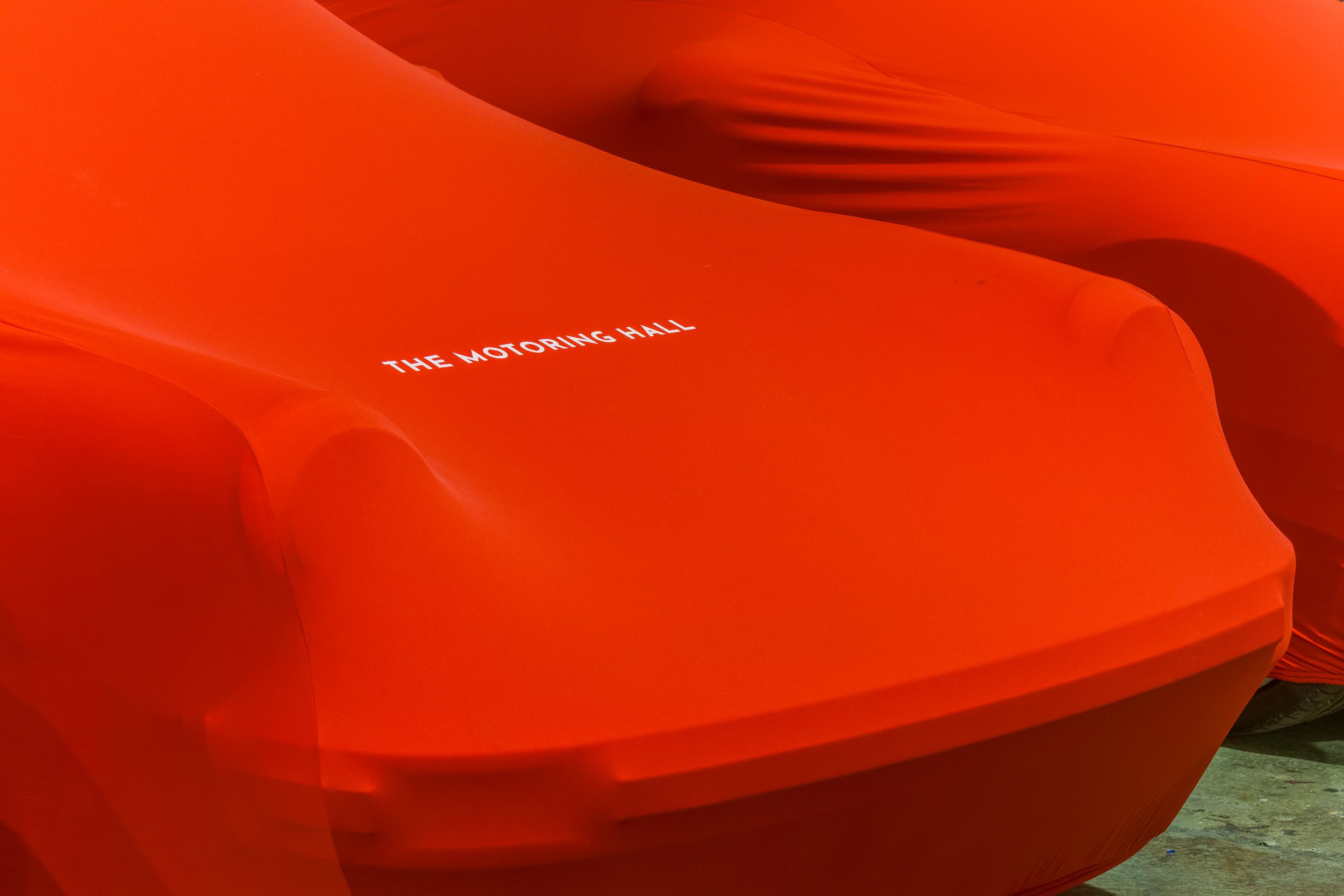Orange cover with the text 'The Motoring Hall' printed on it.
