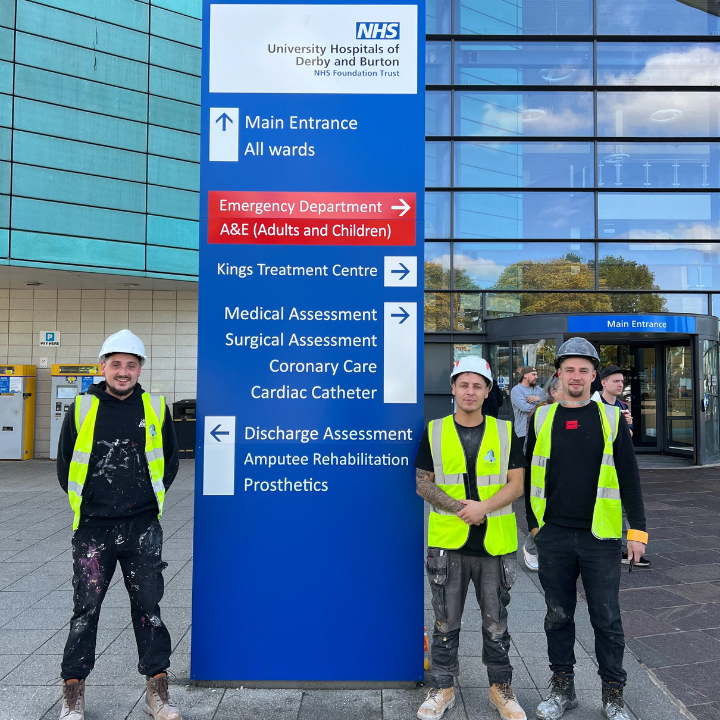 Leads4painters stood next to NHS Derby sign