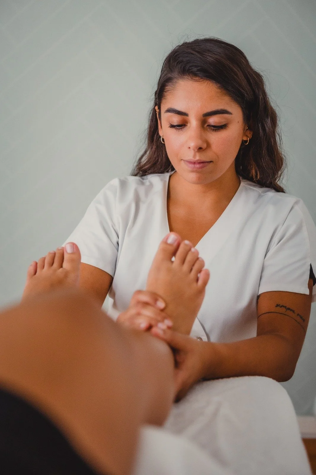 Massage thérapeutique des pieds réalisé lors d’une séance de réflexologie pour stimuler les zones réflexes et rééquilibrer le corps.