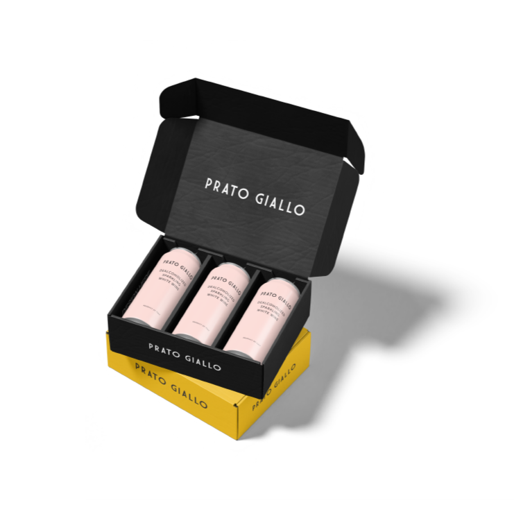 Open black box containing three pink cans labeled 'Prato Giallo' with a yellow outer box.