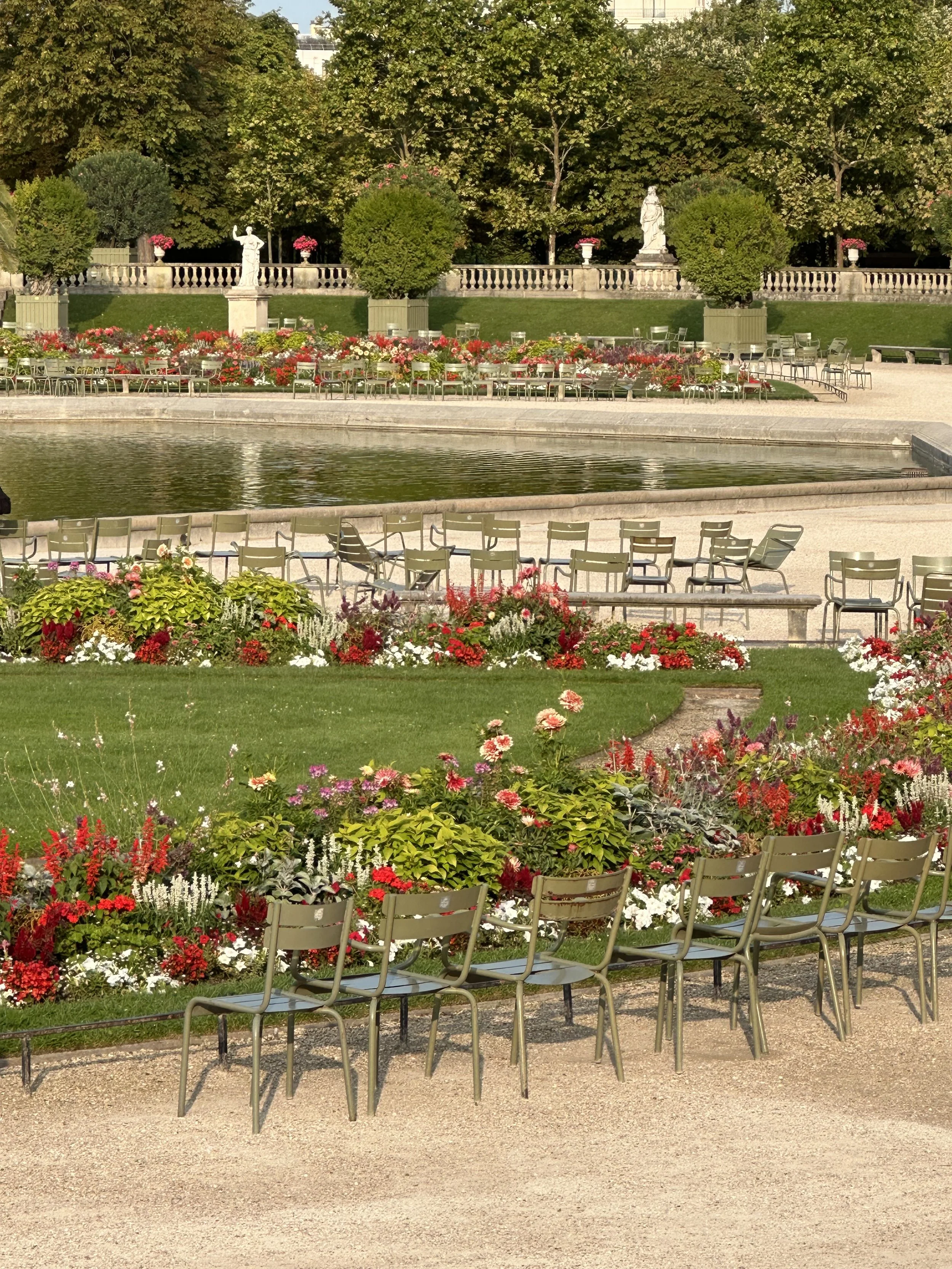 Luxembourg garden in Paris, with the famous green chairs and flower beds