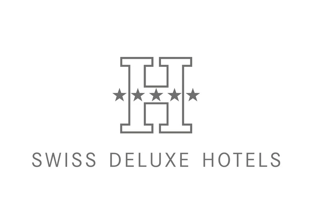 Logo for Swiss Deluxe Hotels featuring a stylized 'H' with five stars and the text 'SWISS DELUXE HOTELS' beneath.