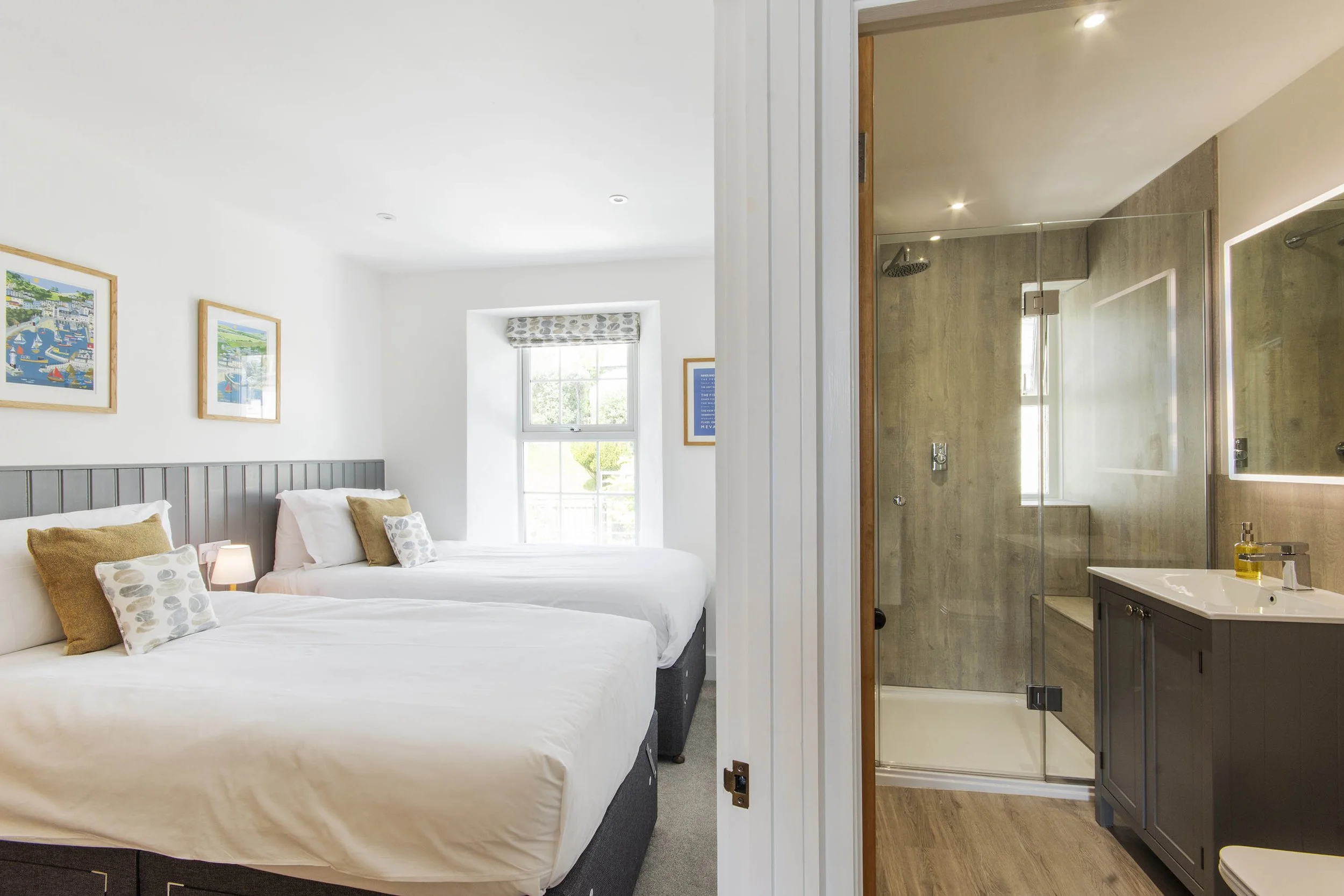 View of the twin bedroom and the bathroom next to it. 