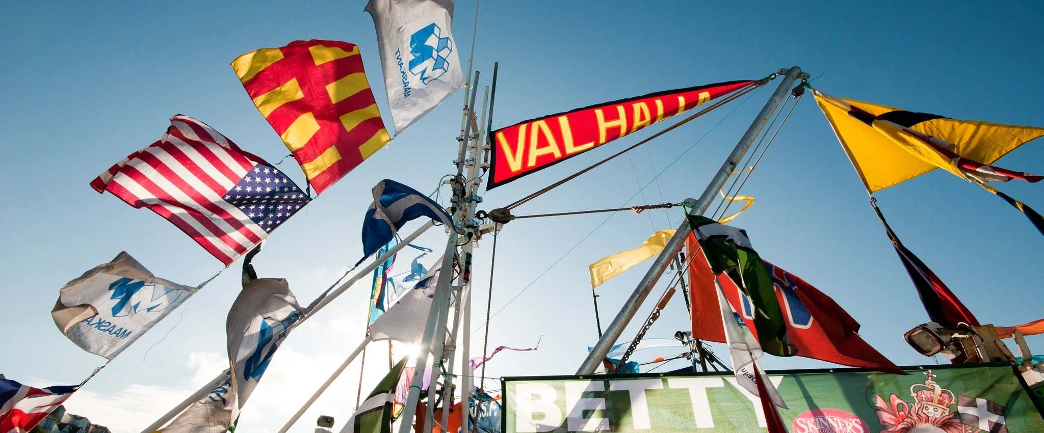 Colourful flags flying on a fishing boat at Mevagissey Feast Week